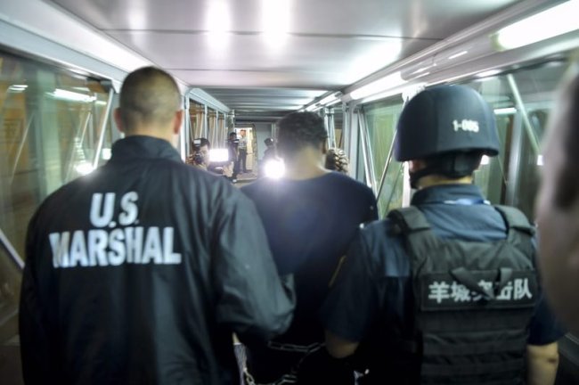 American fugitive Ferguson Naquan boards a plane heading to the US under escort of a Chinese police officer and an American policeman at Guangzhou Baiyun International Airport early Friday morning, August 25, 2017. [Photo: China Plus]