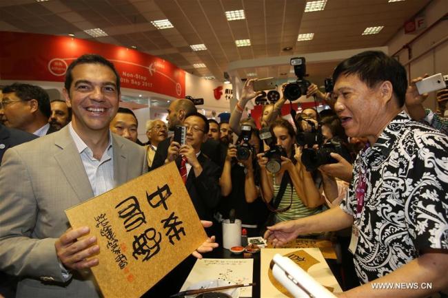 Greek Prime Minister Alexis Tsipras (L) visits the China's exhibition hall at the 82nd Thessaloniki International Fair (TIF) in Thessaloniki, Greece on Sept. 9, 2017. China is an honored country this year in TIF, which is Greece's largest and most prestigious annual trade fair. [Photo: Xinhua]