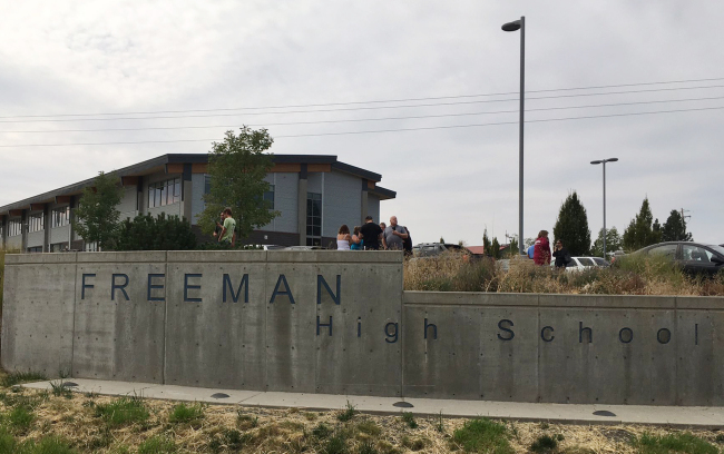 People gather outside of Freeman High School after reports of a shooting at the school in Rockford, Wash., Wednesday, Sept. 13, 2017. [Photo: KHQ via AP]