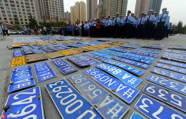 Local police in Lanzhou, the capital city of Gansu province, destroy around 836 illegal license plates on Wednesday. [Photo: China Plus]