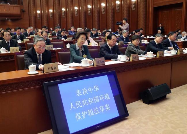 Legislators vote at the closing meeting of the 25th session of the 12th National People's Congress (NPC) Standing Committee in Beijing, capital of China, Dec. 25, 2016. Zhang Dejiang, chairman of the NPC Standing Committee, presided over the meeting.[Photo: Xinhua]