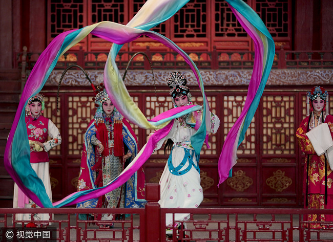 An actress waves her sleeves on the stage at the newly reopened Changyin Pavilion in the Forbidden City on Tuesday, September 19, 2017. [Photo: VCG]