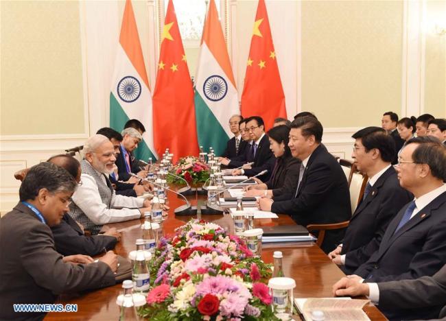 Chinese President Xi Jinping meets with Indian Prime Minister Narendra Modi in Tashkent, Uzbekistan, June 23, 2016.[Photo: Xinhua]
