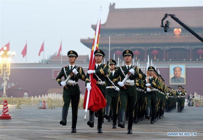 A national flag-raising ceremony is held at the Tian'anmen Square in Beijing, Oct 1, 2017. People from across the country gathered at the square to watch the national flag-raising ceremony on the morning, marking the 68th anniversary of the founding of the People's Republic of China. [Photo: Xinhua]