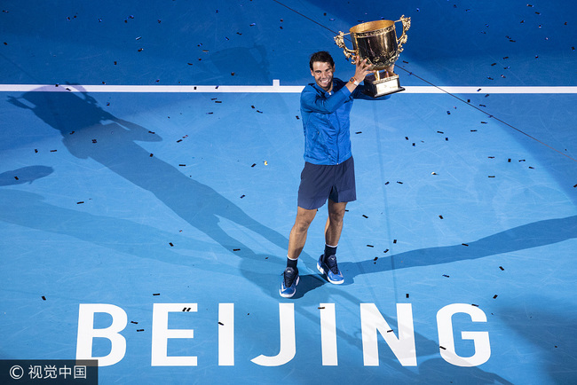 Rafael Nadal of Spain holds the championship trophy after his win over Australian Nick Kyrgios at China Open in Beijing, on October 8, 2017. [Photo: VCG]