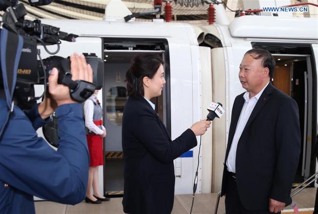 Pi Jinjun (1st R), a delegate of Shandong Province to the 19th National Congress of the Communist Party of China (CPC), receives an interview upon his arrival in Beijing, capital of China, Oct. 16, 2017. Delegates of Shandong Province to the 19th CPC National Congress arrived in Beijing on Monday. The congress will start on Oct. 18 in Beijing. [Photo: Xinhua]