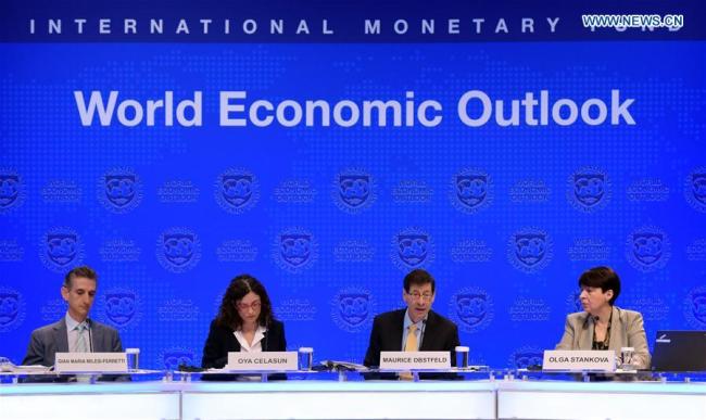 Maurice Obstfeld (2nd R), chief economist at the International Monetary Fund (IMF), attends a press briefing at the IMF headquarters in Washington D.C., the United States, on Oct. 10, 2017. The IMF on Tuesday raised its global growth forecast for 2017 and 2018 due to a broad-based recovery in Europe, China, Japan and the United States. [Photo: Xinhua]