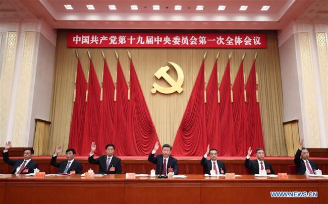 Xi Jinping (C), Li Keqiang (3rd R), Li Zhanshu (3rd L), Wang Yang (2nd R), Wang Huning (2nd L), Zhao Leji (1st R) and Han Zheng (1st L) attend the first plenary session of the 19th Communist Party of China (CPC) Central Committee at the Great Hall of the People in Beijing, capital of China, Oct. 25, 2017. [Photo: Xinhua/Ju Peng]