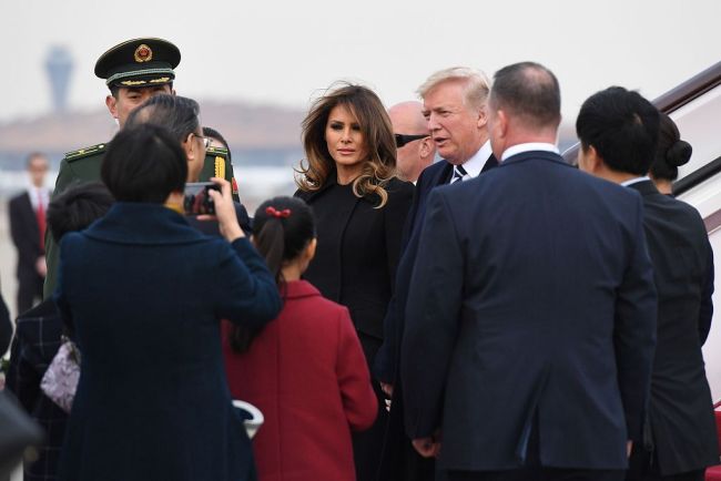 US President Donald Trump and First Lady Melania Trump are greeted as they arrive in Beijing on November 8, 2017. [Photo: VCG]
