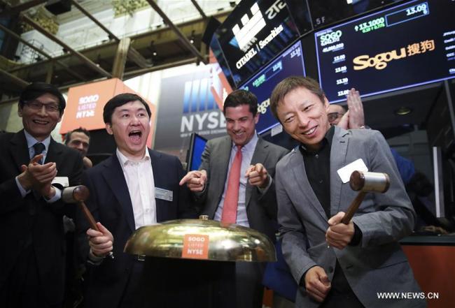CEO of Sogou Inc. Wang Xiaochuan (2nd L, Front) and CEO of sohu.com Zhang Chaoyang (1st R, Front) attend the opening bell ceremony at the New York Stock Exchange in New York, the United States, on Nov. 9, 2017. Sogou Inc., a Chinese search engine company backed by Tencent and Sohu, rang the New York Stock Exchange (NYSE) opening bell on Thursday in celebration of its initial public offerings (IPO). Shares of Sogou, trading under the ticker symbol "SOGO", started trading at 13 dollars per ADS on Thursday, and closed at 13.50 dollars apiece, rising 3.85 percent. [Photo: Xinhua/Wang Ying]