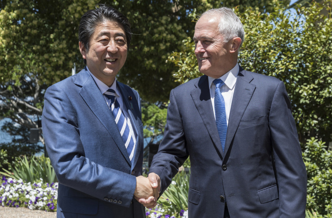 Japanese Prime Minister Shinzo Abe, left, shakes hands with Australian Prime Minister Malcom Turnbull at Kirribilli House in Sydney Saturday, Jan. 14, 2017. [File Photo: Brook Mitchell/Pool via AP]