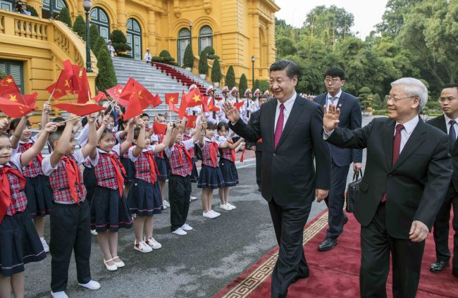 Chinese President Xi Jinping, also general secretary of the Communist Party of China Central Committee, attends a grand welcome ceremony hosted by Nguyen Phu Trong, general secretary of the Communist Party of Vietnam Central Committee, ahead of their talks in Hanoi, Vietnam, Nov. 12, 2017. [Photo: Xinhua/Li Tao]