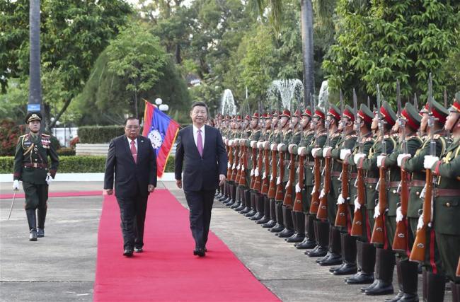 Chinese President Xi Jinping, also general secretary of the Communist Party of China Central Committee, attends a grand welcome ceremony held by Bounnhang Vorachit, general secretary of the Lao People's Revolutionary Party (LPRP) Central Committee and president of Laos, before their talks in Vientiane, Laos, Nov. 13, 2017. [Photo: Xinhua/Ma Zhancheng]