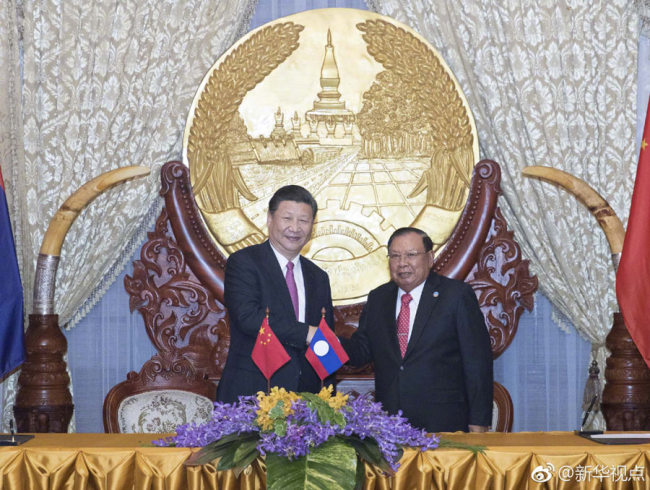 Chinese President Xi Jinping, also general secretary of the Communist Party of China (CPC) Central Committee, met with Bounnhang Vorachit, general secretary of the Lao People's Revolutionary Party (LPRP) Central Committee and president of Laos. [Photo: Xinhua]