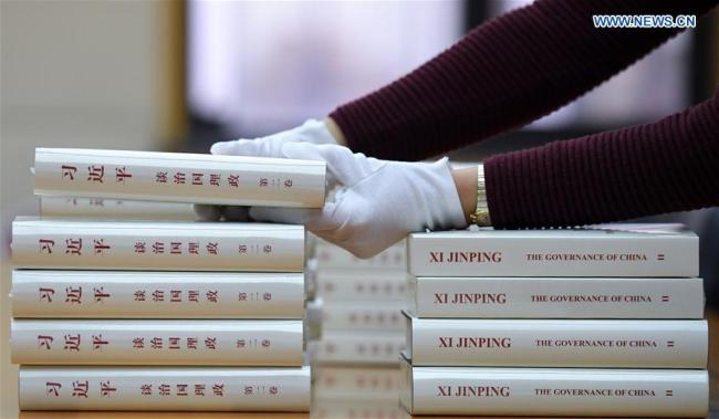 A worker from the Foreign Languages Press puts the second volume of Chinese President Xi Jinping's book "Xi Jinping: The Governance of China" in order, in Beijing, capital of China, Nov. 7, 2017. The second volume of Chinese President Xi Jinping's book on governance has been published in both Chinese and English, the publisher said Tuesday. [Photo: Xinhua/Chen Yehua]