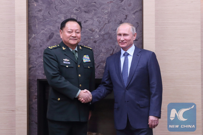 Russian President Vladimir Putin shakes hands with Zhang Youxia, a top Chinese military official, in Moscow, Russia, Dec. 7, 2017. [Photo: Xinhua]