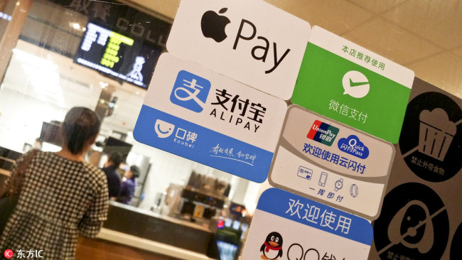 A store's signboard shows a variety of mobile payment apps are accepted, including Alipay, WeChat Pay, Tencent's QQ Wallet, Apple Pay and UnionPay's QuickPass, in Guangzhou, south China's Gngdong Province on May 11, 2017. [File photo: IC]