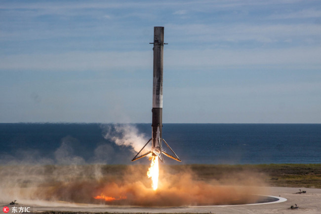 The SpaceX Falcon 9 first stage rocket successfully lands on Landing Zone 1 after carrying the Dragon capsule into Earth Orbit at the Cape Canaveral Spaceport December 15, 2017 in Cape Canaveral, Florida. The Dragon capsule is on a resupply run to the International Space Station and is the first time SpaceX launched a pre-flown rocket and spacecraft on a NASA mission. [Photo: IC]