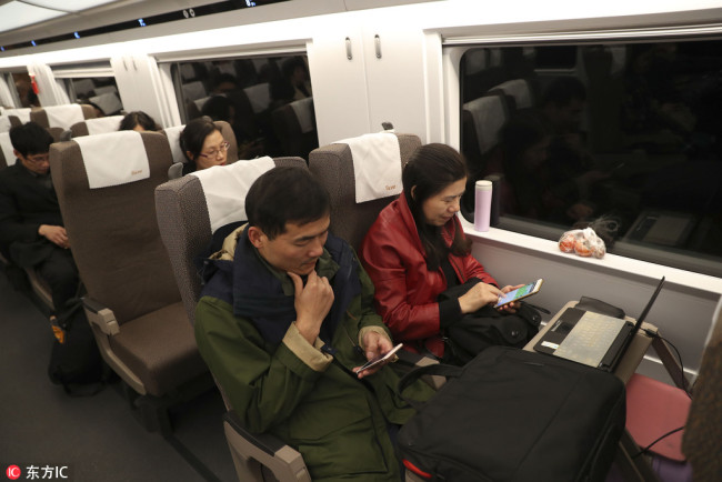 Passengers get access to free Wi-Fi services on the Fuxing bullet train. [Photo: IC]