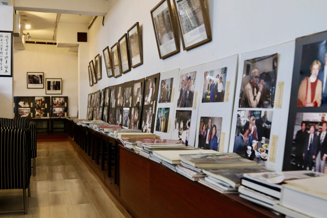The corridor of Sanwei Shuwu with many photos on the wall showing the history and the story of the bookstore. [Photo: China Plus/ Li Xiang]