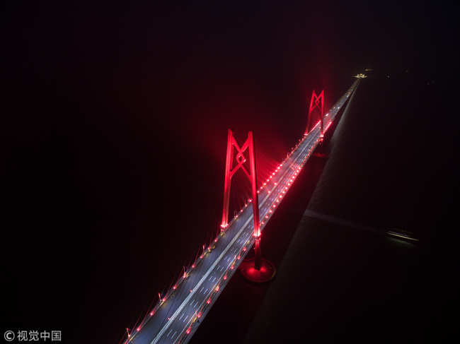 Aerial photo shows the Hong Kong-Zhuhai-Macao Bridge lighting up on Sunday, December 31, 2017. In the next month, engineers will conduct various tests on the bridge's systems and equipment. [Photo: VCG]