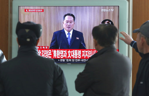 People watch a public TV screen showing a North Korean newscaster reading a statement at Seoul Railway Station in Seoul, South Korea, Wednesday, Jan. 3, 2018. [Photo: AP/Ahn Young-joon]