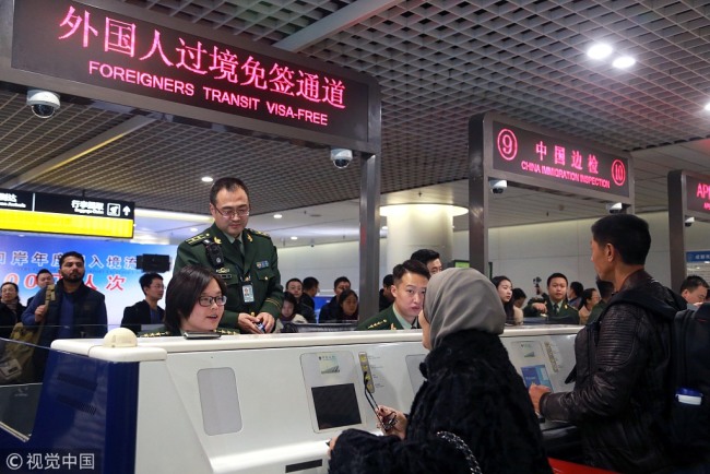 Police officers receive foreign citizens at an international airport in the southwestern Chinese city of Chengdu, December 14, 2017. [Photo: VCG]