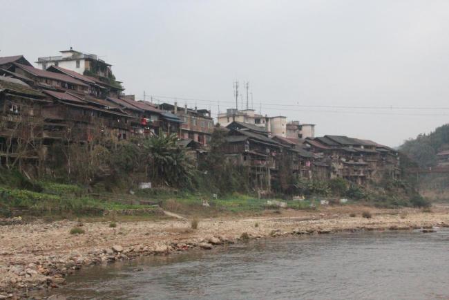 Danian village in Sanjiang County, Guangxi Zhuang Autonomous Region, is divided in half by the Danian River. Old wooden buildings flank the river, and important occasions often take place on the dry riverbed and riverbanks. [Photo: Provided to China Plus/Lu Zhiyan]