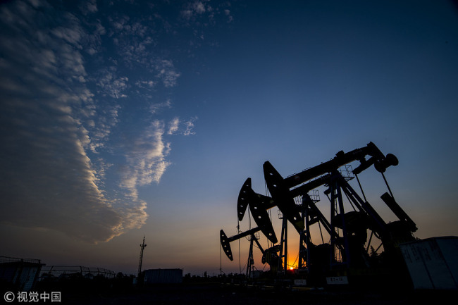 Oil pumps work at sunset in an oil field in Nantong, east China’s Jiangsu Province, August 27, 2016. [File photo: VCG]