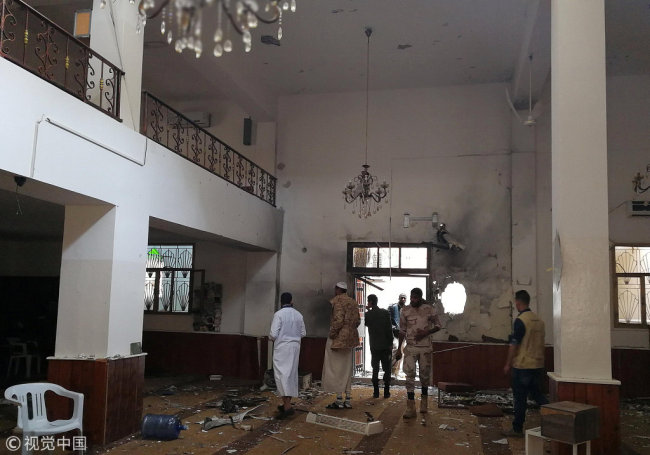 People inspect the damage inside a mosque following a twin bombing in Benghazi, Libya February 9, 2018. [Photo: VCG]