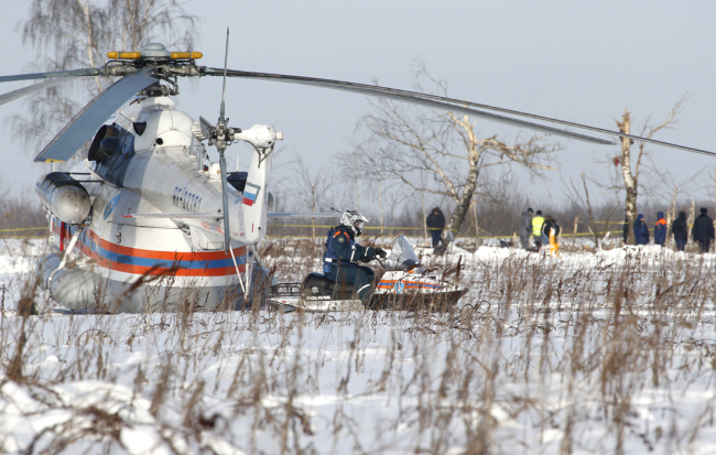 Russian Emergency Situations Ministry employees and Russian police officers work at the scene of a AN-148 plane crash in Stepanovskoye village, about 40 kilometers (25 miles) from the Domodedovo airport, Russia, Monday, Feb. 12, 2018. [Photo: AP/Alexander Zemlianichenko]