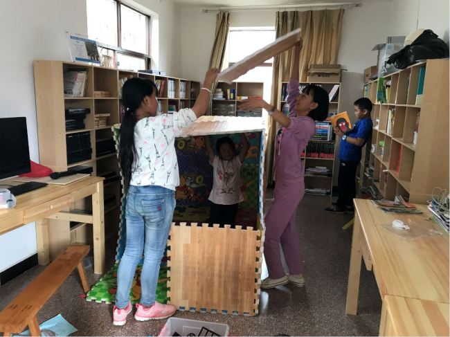 Children were having fun and playing games together in the Children's Happy House. [photo: from China Plus]    