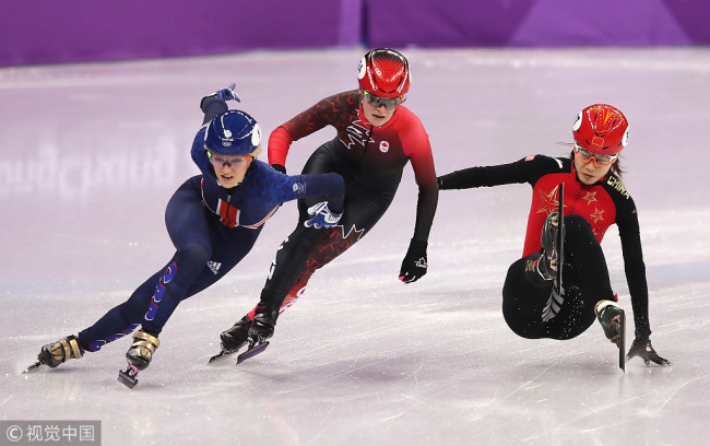 Elise Christie of Great Britain and Kim Boutin of Canada get past a falling Chunyu Qu of China during the Ladies' 500m Short Track Speed Skating semifinal on day four of the PyeongChang 2018 Winter Olympic Games at Gangneung Ice Arena on February 13, 2018 in Gangneung, South Korea. [Photo: VCG]