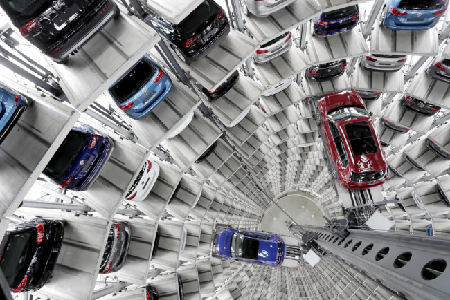 Volkswagen cars are lifted inside a delivery tower of the company in Wolfsburg, Germany, March 14, 2017. [Photo: AP]