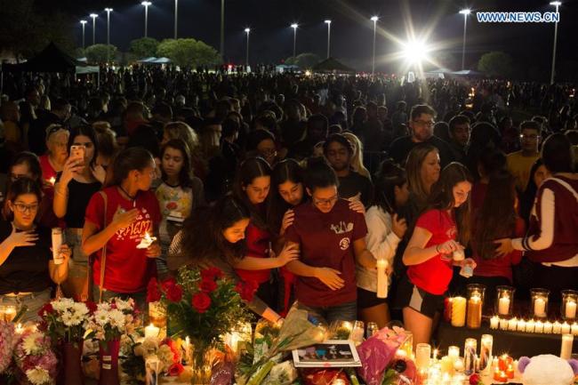 People attend a vigil for the victims of the shooting at Marjory Stoneman Douglas High School, in Pine Trails Park in Parkland, Florida, the United States, on Feb. 15, 2018. A total of 17 people were killed and 14 others wounded in a mass shooting in a high school in Florida in the United States Wednesday. [Photo: Xinhua]