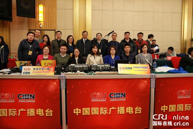 Live broadcast team members of China Radio International pose for a photo ahead of a news conference held by Chinese Foreign Minister Wang Yi in Beijing, on March 8, 2018. [Photo: China Plus]