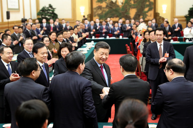 Chinese President Xi Jinping, also general secretary of the Communist Party of China (CPC) Central Committee and chairman of the Central Military Commission, joins a panel discussion with deputies from Chongqing Municipality at the first session of the 13th National People's Congress in Beijing on Saturday, March 10, 2018. [Photo: Xinhua]