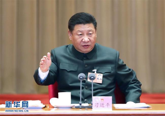 Xi Jinping attends a plenary meeting of the delegation of People's Liberation Army and armed police at the ongoing session of the 13th National People's Congress on March 12, 2018. [Photo: Xinhua]