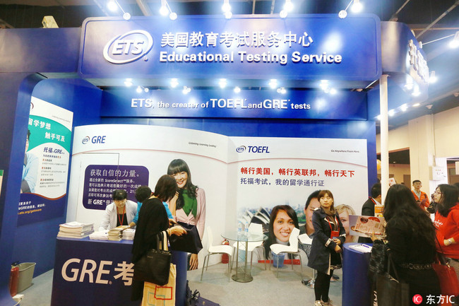 People visit the booth of ETS (Education Testing Service) to get information about TOEFL (Test of English as a Foreign Language) and GRE (Graduate Record Examination) during the China International Education Exhibition Tour 2014 in Beijing, China, 25 October 2014.