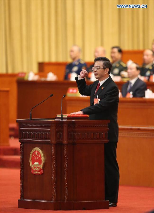 Zhou Qiang takes an oath of allegiance to the Constitution in the Great Hall of the People in Beijing, capital of China, March 18, 2018. Zhou Qiang was elected president of the Supreme People's Court (SPC) Sunday at the first session of the 13th National People's Congress, China's national legislature. [Photo: Xinhua/Yao Dawei]
