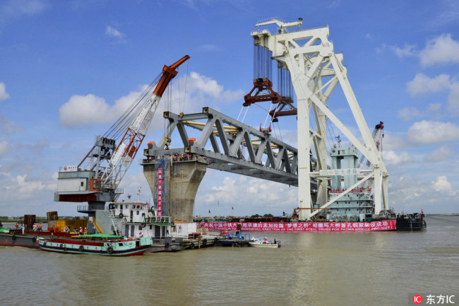 A span is placed on the pillar 37 and 38 of the Padma Bridge at the Jajira point in Shariatpur, Bangladesh on Saturday, September 30, 2017. [Photo: IC]