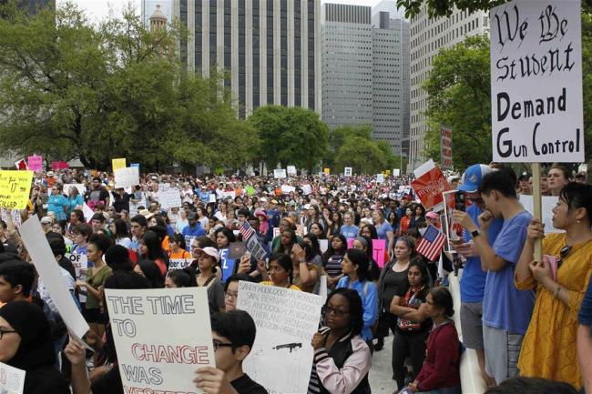 People take part in the "March for Our Lives" gun control rally in Houston, the United States, on March 24, 2018. Hundreds of thousands of people took to the streets in downtown Houston in U.S. southern state of Texas on Saturday for the "March for Our Lives" gun control rally, demanding the end of gun violence and mass school shootings. [Photo: Xinhua/Song Qiong]