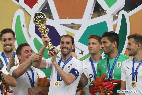 Players of Uruguay celebrate with their trophy during the awarding ceremony of the 2018 China Cup International Football Championship in Nanning, capital of south China's Guangxi Zhuang Autonomous Region, March 26, 2018. Uruguay won the final by 1-0 against Wales and claimed the title of the event. [Photo: Xinhua/Cao Can]
