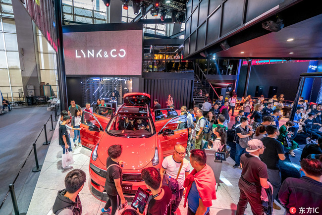 People visit the stand of Lynk & Co, partly owned by Volvo Cars and Zhejiang Geely Holding, during the 15th China (Guangzhou) International Automobile Exhibition, also known as Auto Guangzhou 2017, in Guangzhou city, south China´s Guangdong province, 18 November 2017. 