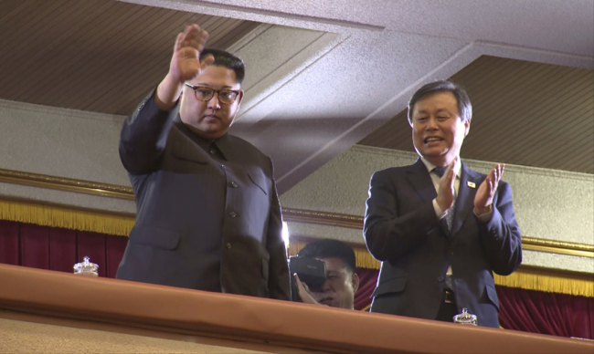 In this Sunday, April 1, 2018, image from video, North Korean leader Kim Jong Un, left, waves as South Korean Culture, Sports and Tourism Minister Do Jong-whan claps during a performance by a South Korean art troupe in Pyongyang, North Korea. Kim clapped his hands as he, along with his wife and hundreds of other citizens, watched a rare performance by South Korean pop stars visiting Pyongyang, highlighting the thawing ties between the rivals after years of heightened tensions over the North's nuclear program. [Photo: AP]