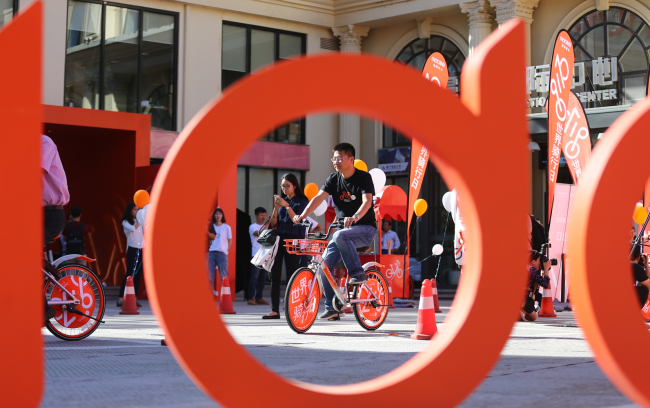 People ride Mobike bicycles. [File photo: China Plus]