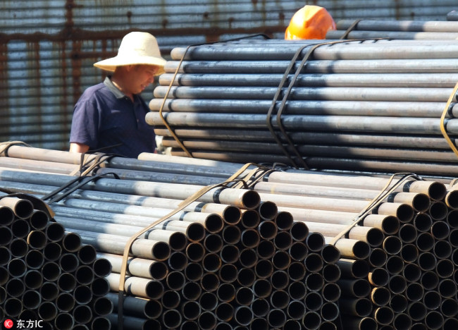 Workers check steel pipes to be exported at a steel market in Yichang, central China's Hubei Province, September 11, 2016. [Photo: IC]