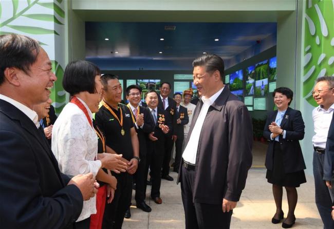 Chinese President Xi Jinping, also general secretary of the Communist Party of China Central Committee and chairman of the Central Military Commission, talks with model workers and representatives of different occupations at a plaza of the Hainan Museum in Haikou, south China's Hainan Province, April 13, 2018. Xi made an inspection tour in Hainan from Wednesday to Friday. [Photo: Xinhua]