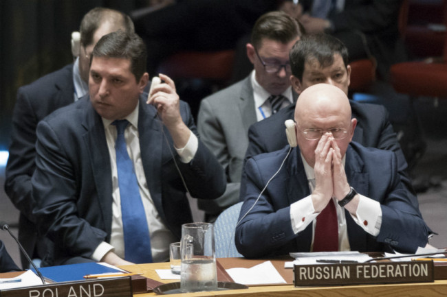 Russian Ambassador to the United Nations Vassily Nebenzia listens as Syrian Ambassador to the United Nations Bashar Ja'afari speaks after a vote on a resolution during a Security Council meeting on the situation in Syria, Saturday, April 14, 2018 at United Nations headquarters. [Photo: AP]