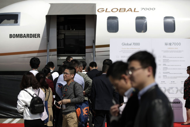 Chinese visitors line-up to go inside a Canada's Bombardier Global 7000 business jet cabin on display at Hongqiao International Airport during the Asian Business Aviation Conference and Exhibition (ABACE) in Shanghai, Tuesday, April 17, 2018. [Photo: AP]